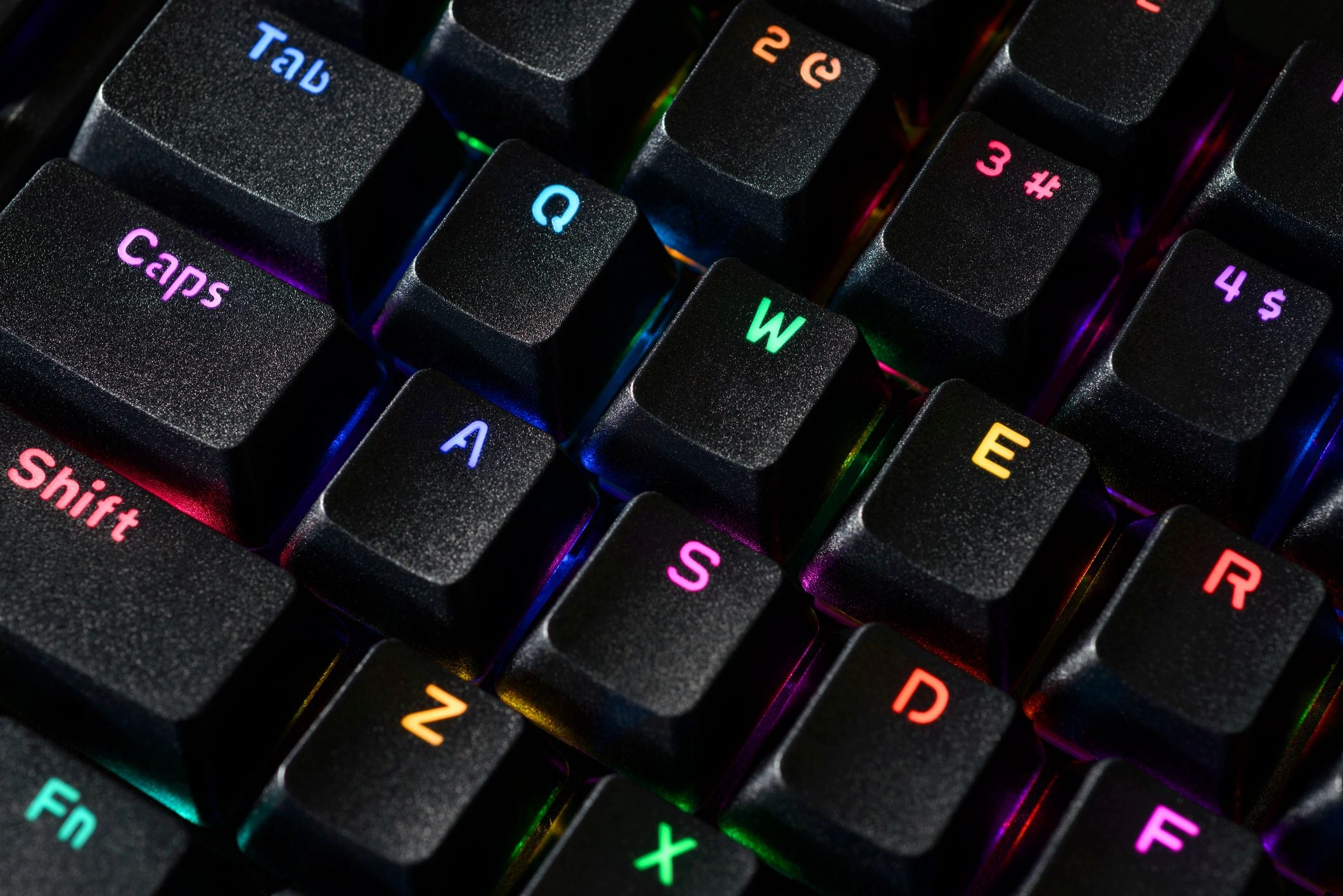 RGB-lit gaming keyboard, focus on Tab, Caps, Shift.